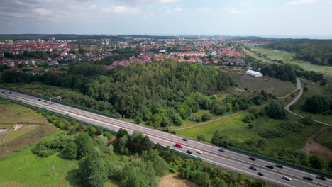 Aerial-View-Of-Vehicles-Driving-In-The-Road-Near-The-Town-In-Gdynia,-Poland