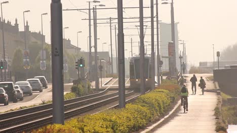 urban commute with tram, cars, cyclists, and pedestrians