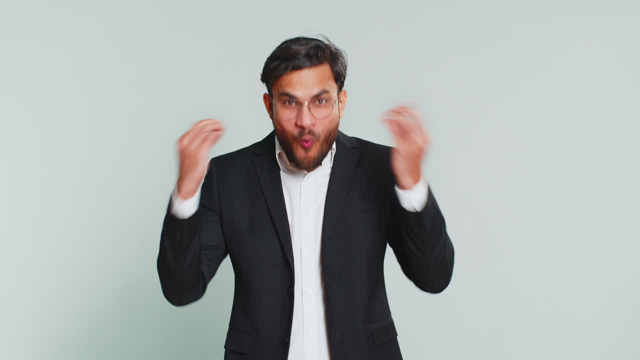 Businessman touching head and showing explosion looking worried shocked inspiration brainstorm