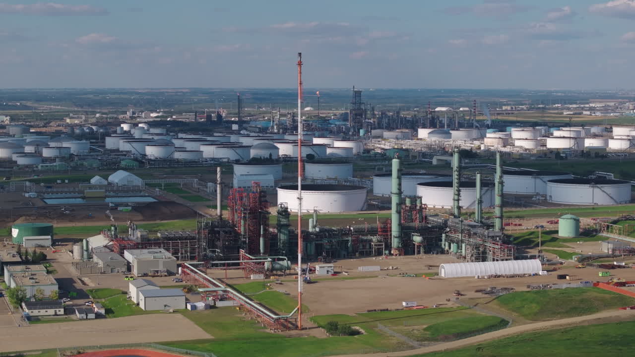 Aerial view of large industrial refinery with tanks and chimneys