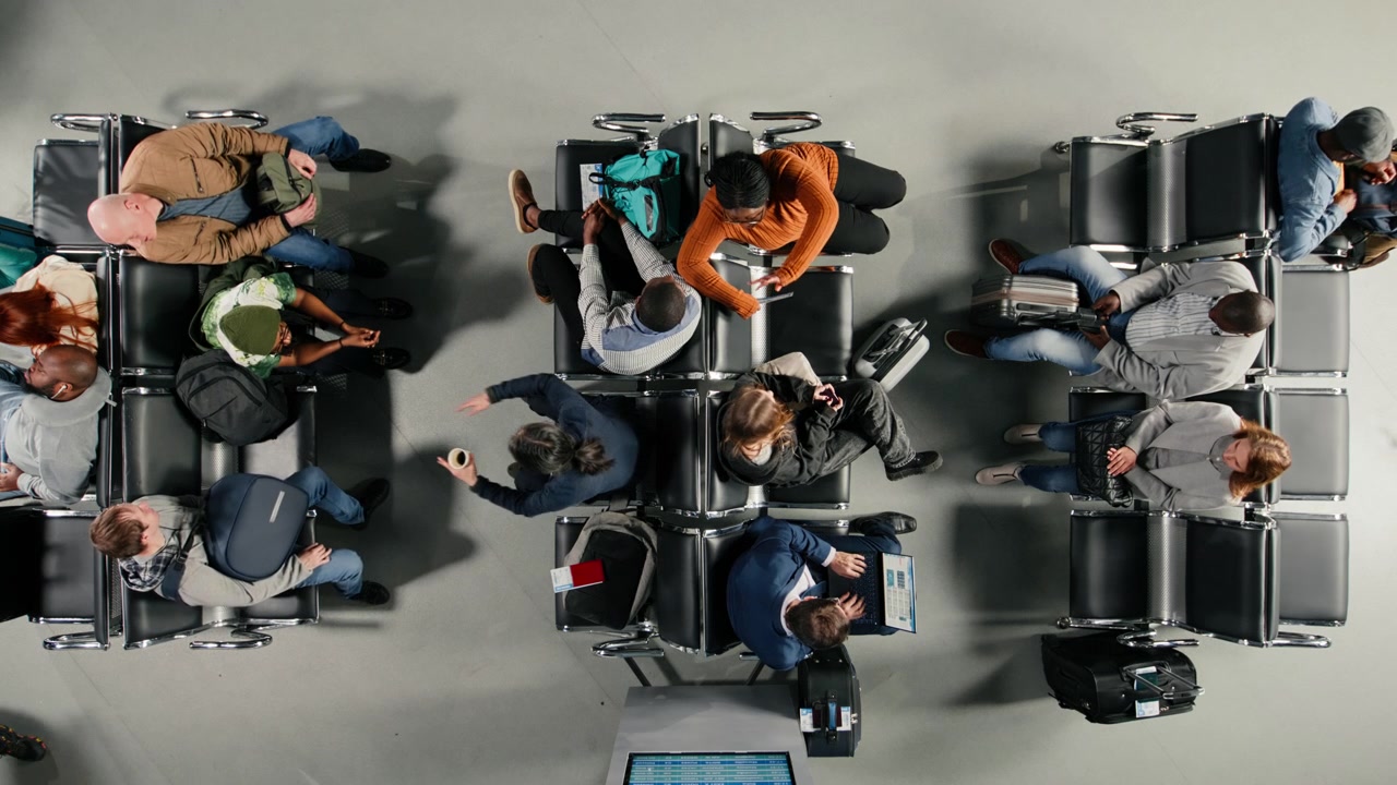 Checking visa documents, talking and people in airport hub, top down view