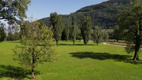 Smooth-high-frame-rate-flying-drone-shot-of-Switzerland-nature-green-field-grassland-in-a-sunny-day-in-summer-spring-season-alps-mountain-alpine-highland-landscape-clear-blue-sky-and-wonderful-shadows