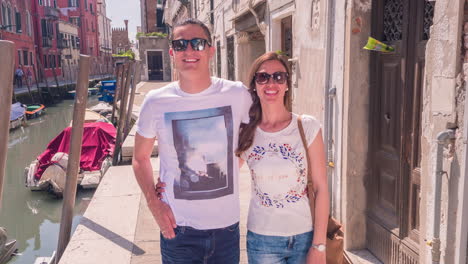 couple enjoying a walk through venice canals