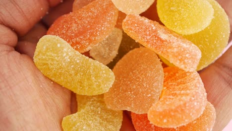 close-up of colorful sugar-coated gummy candies in a hand