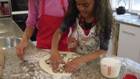 family making christmas cookies at home