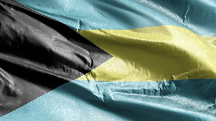 Bahamas textile flag slow waving on the wind loop. Bahamian banner smoothly swaying on the breeze. Fabric textile tissue. Full filling background. 20 seconds loop.