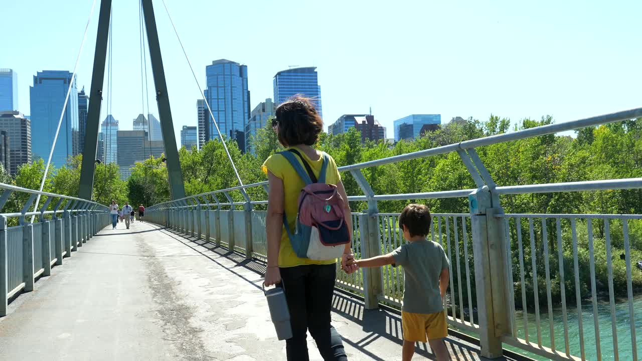 Mother and Child Walking on Bridge