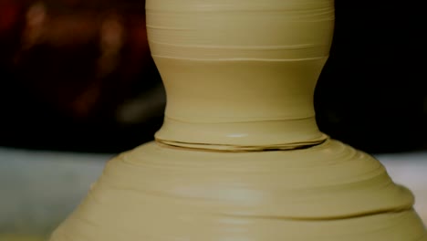 professional male potter working in workshop, studio