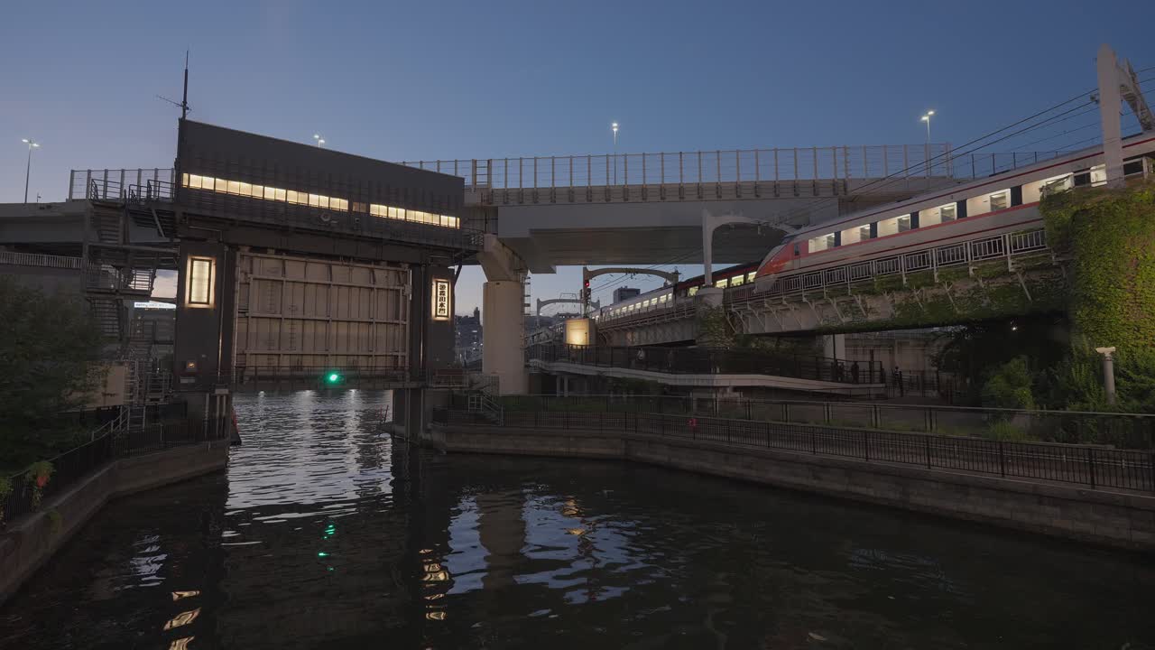 Cityscape with River, Train, and Lock at Night