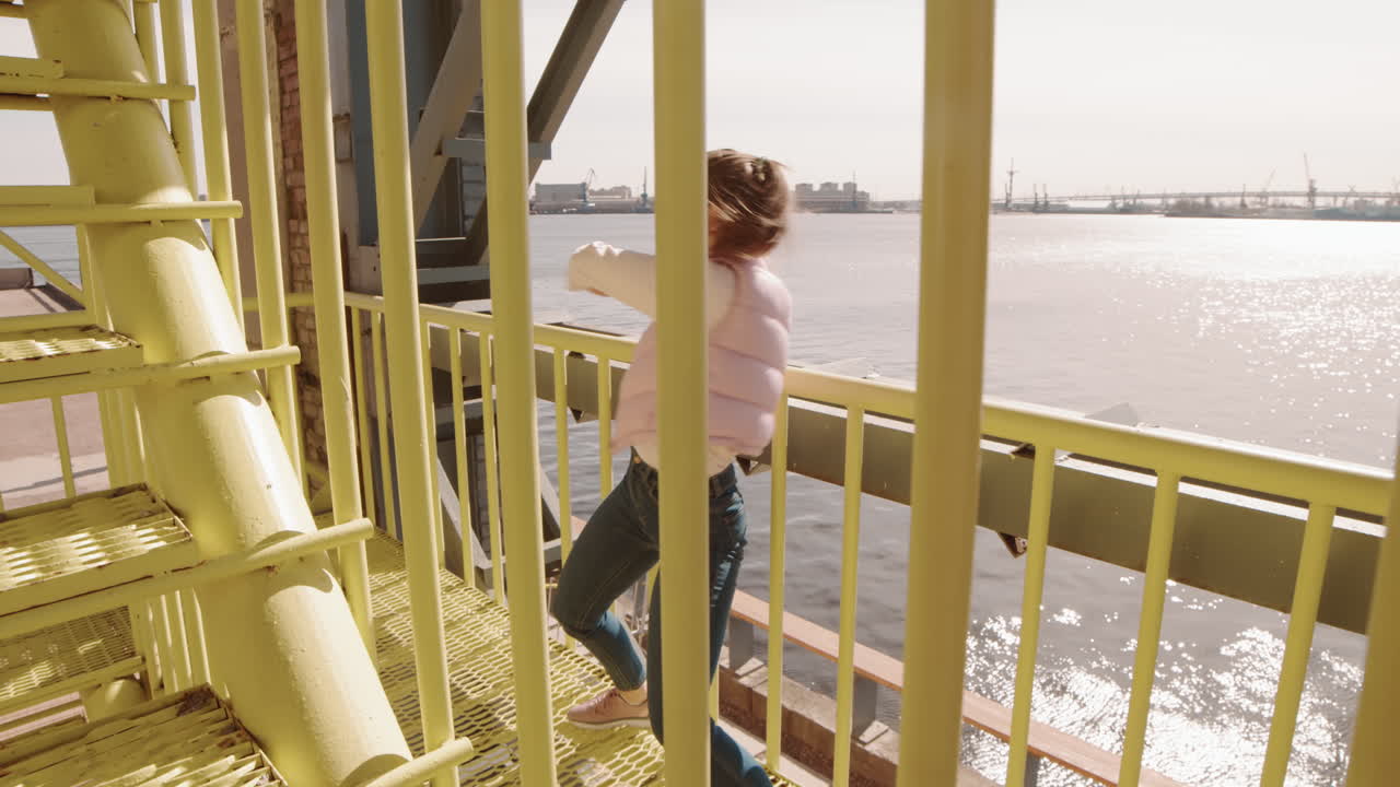 Caucasian Woman Dancing by Metallic Fencing