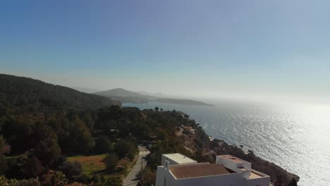 drone rising by a building by the coast on ibiza