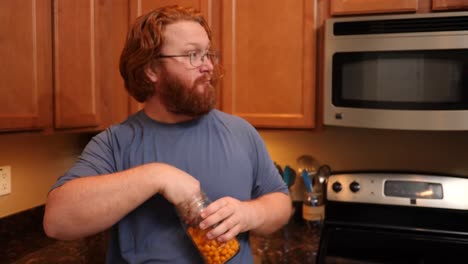 casual view of red hair male eating chips