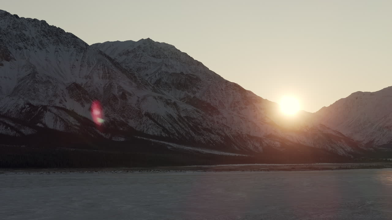 Snowy Mountain And Frozer River At Sunrise. - aerial shot