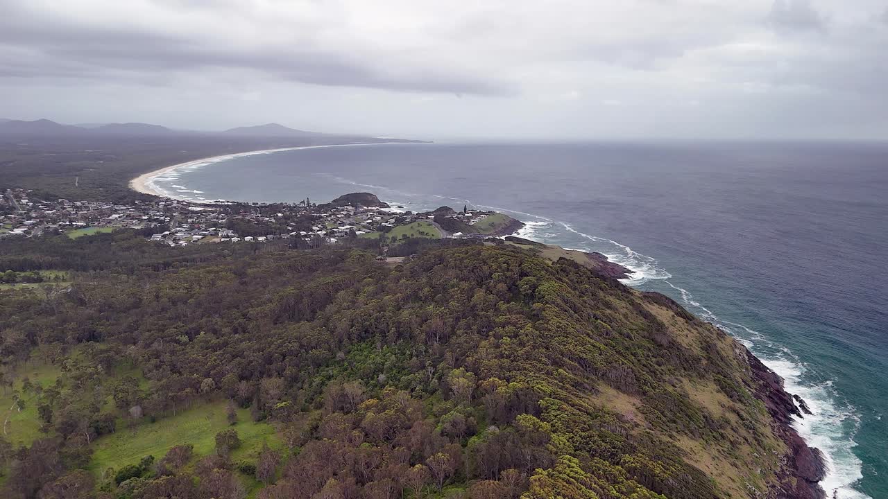 Hazy overcast flight over forest hills to Scotts Head, NSW, Australia