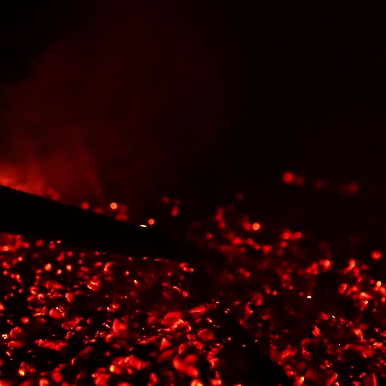 Red heat on black background. Fireplace explosion slow motion