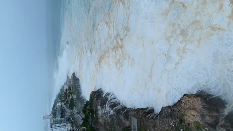 Vertical-video,-waves-breaking-at-rocky-Caribbean-coastline,-hurricane-Beryl