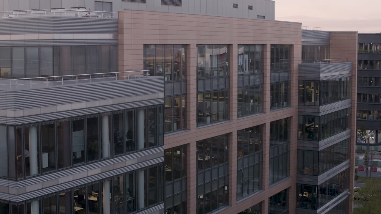Modern office building at sunset with a panning shot highlighting the architecture