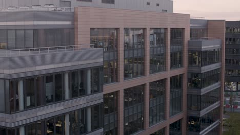 modern office building at sunset with a panning shot highlighting the architecture