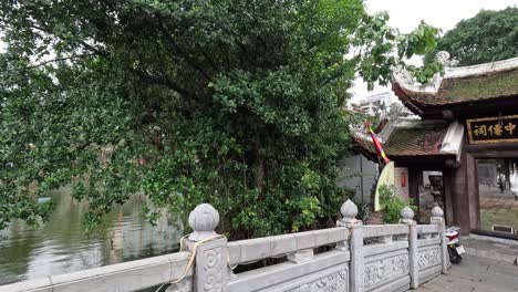 temple entrance with bridge and lush greenery