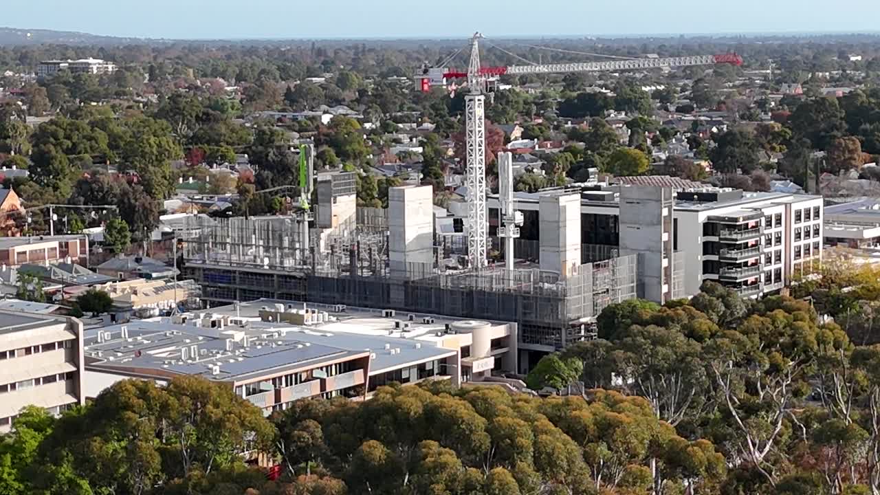 Drone shot of a construction site with a white crane