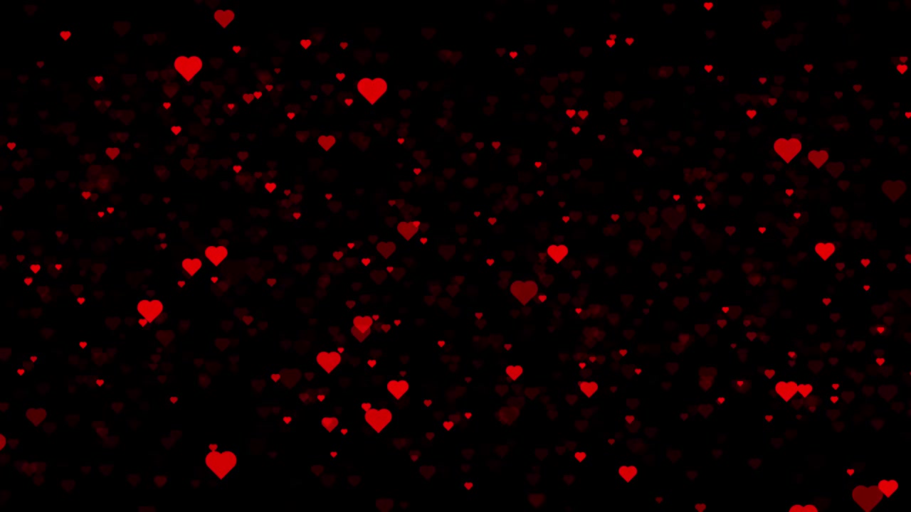 Animazione a particelle di cuori rossi che si alzano, isolata su sfondo nero.