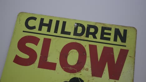 close up footage of a road sign that says "children slow