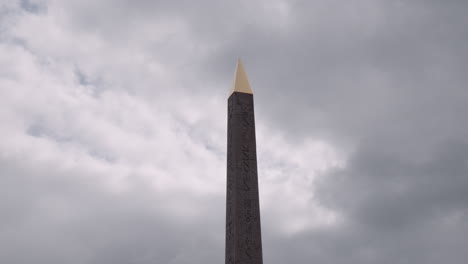 stunning view of the egyptian obelisk of luxor standing tall at place de la concorde on a cloudy day in paris, france