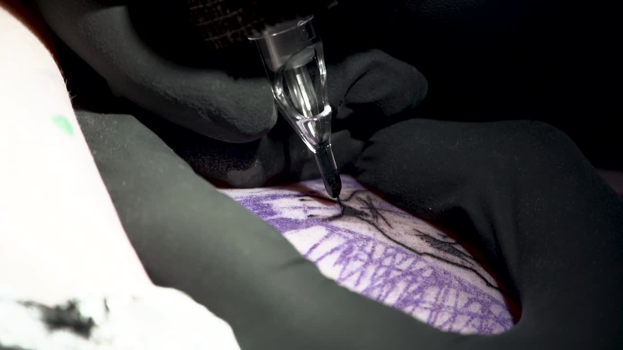 Extreme Close up, Black Gloves of Tattoo Artist working on face and neckline of Sketched Style Mermaid Tattoo