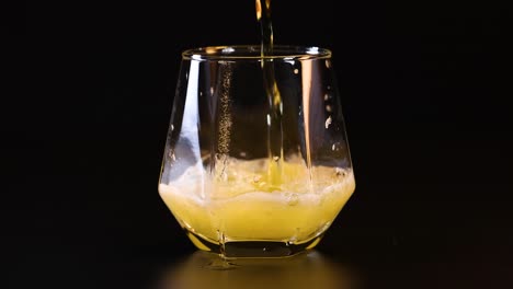 beer overflows as it is poured into glass