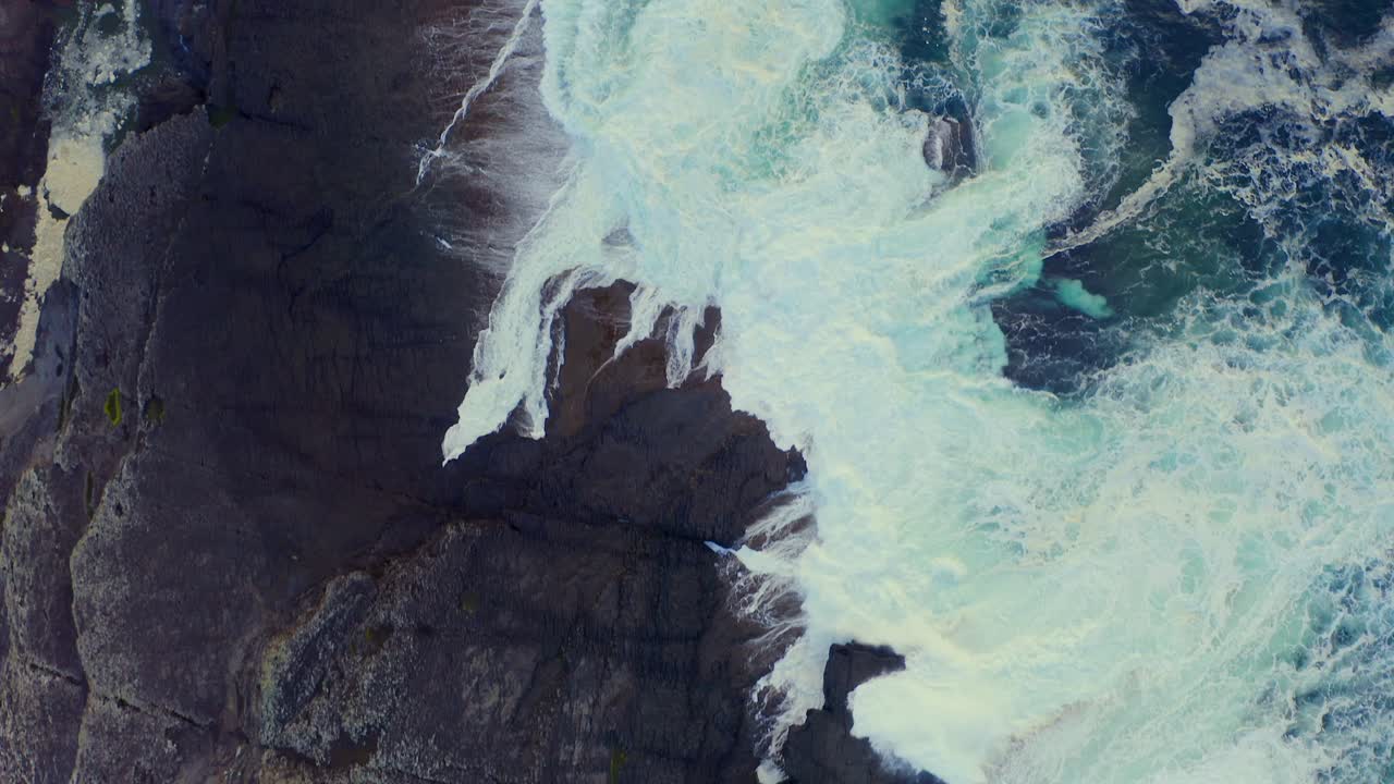 Ocean waves crashing rocks on Loop Head Peninsula and Bridges of Ross area at evening, Ireland