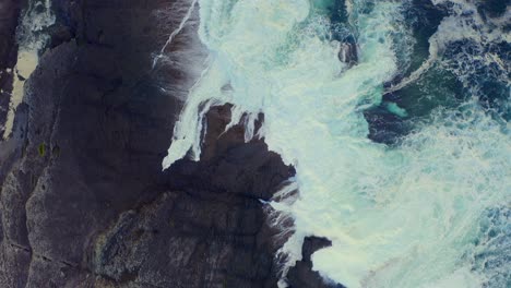 ocean waves crashing rocks on loop head peninsula and bridges of ross area at evening, ireland