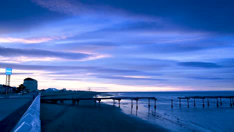 4K-Colourful-sunrise-time-lapse-over-the-remains-of-the-Loreto-Pier-in-Punta-Arenas,-Chilean-Patagonia,-Chile-moving