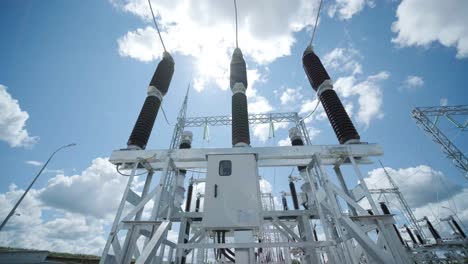 high voltage transformer against the blue sky. electric current redistribution substation