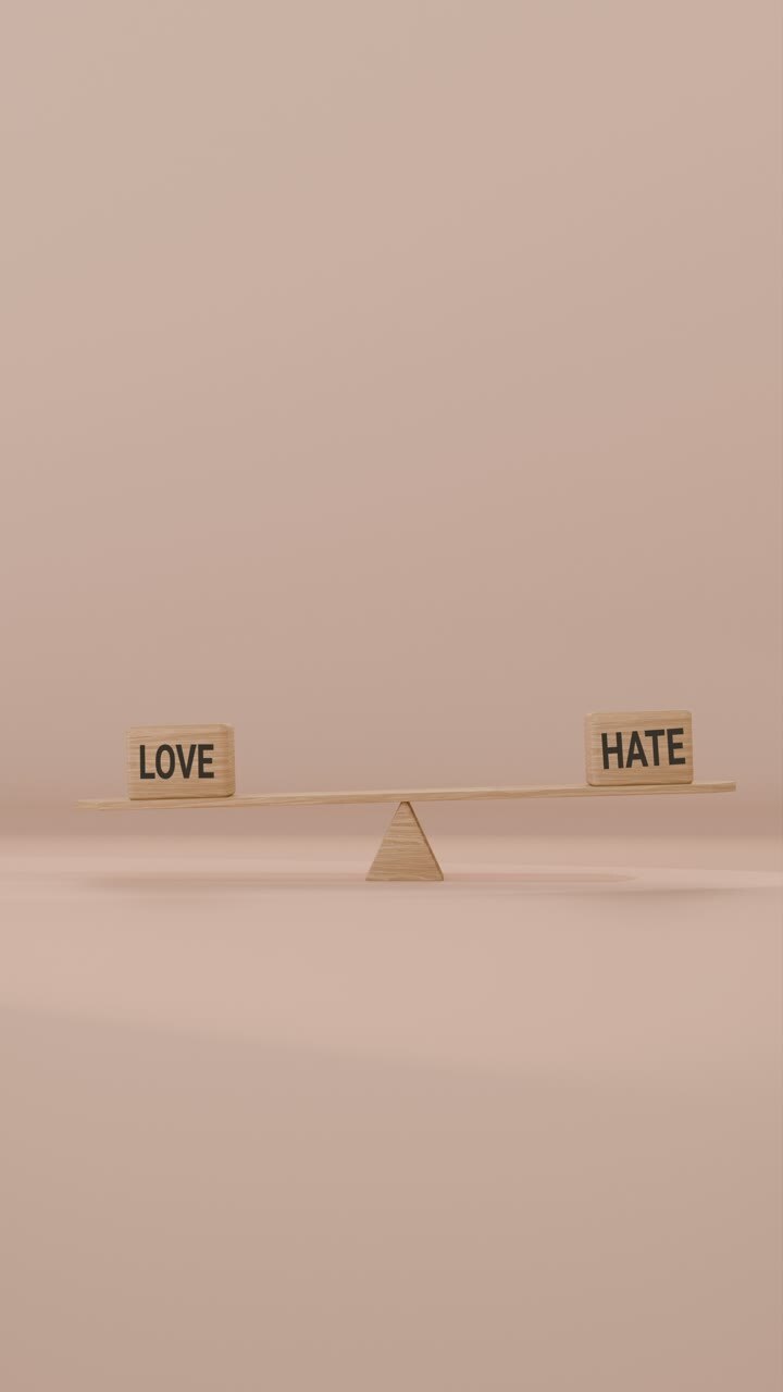 VERITCAL VIDEO OF LOVE AND HATE BALANCING ON SEESAW