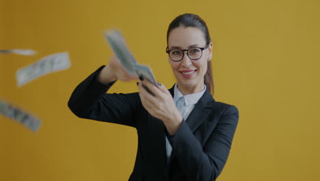 woman throwing money while using a smartphone