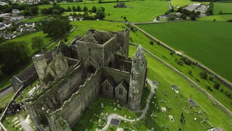 Aerial-drone-shot-of-castle-and-grassy-landscapes-in-Ireland