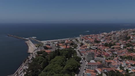 aerial of foz in porto with red rooftops meeting the deep blue atlantic and coastal piers