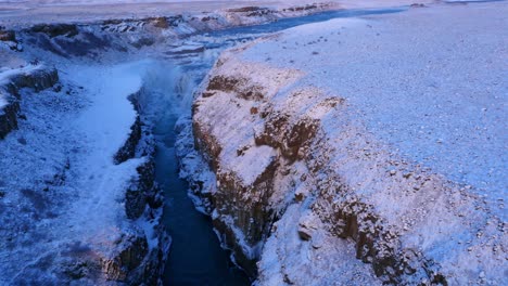 aerial view of frozen gulfoss waterfall in iceland with wild river