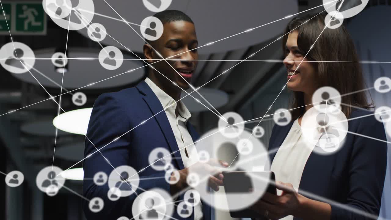Man tapping tablet, woman holding tablet in business corridor, network nodes expanding to map links
