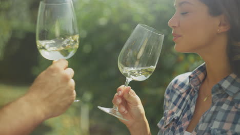 couple wine tasting in vineyard