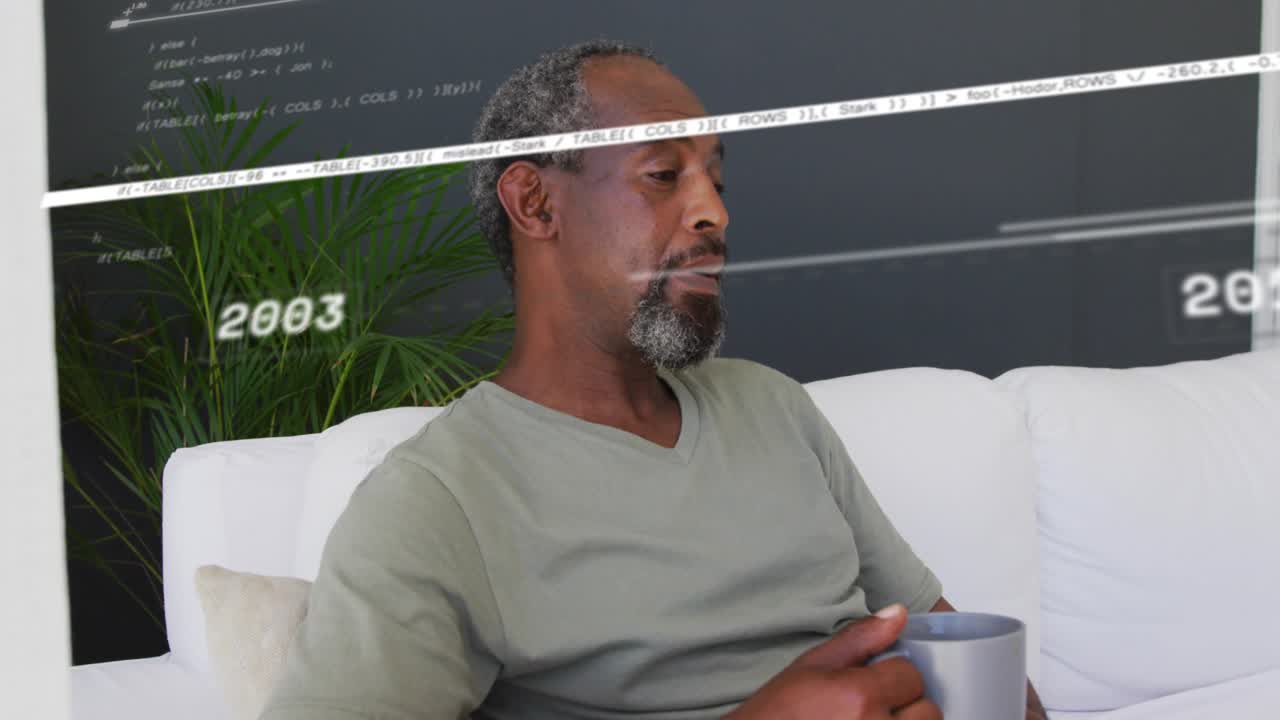 Mature man sitting on sofa holding mug, reacting to tech timeline sweeping face, reviewing years