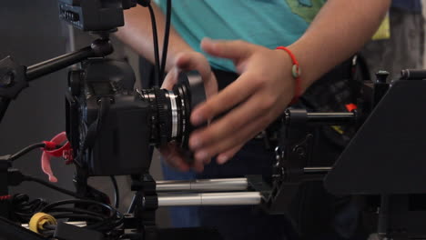 camera operator puts lens in a professional film rig camera system