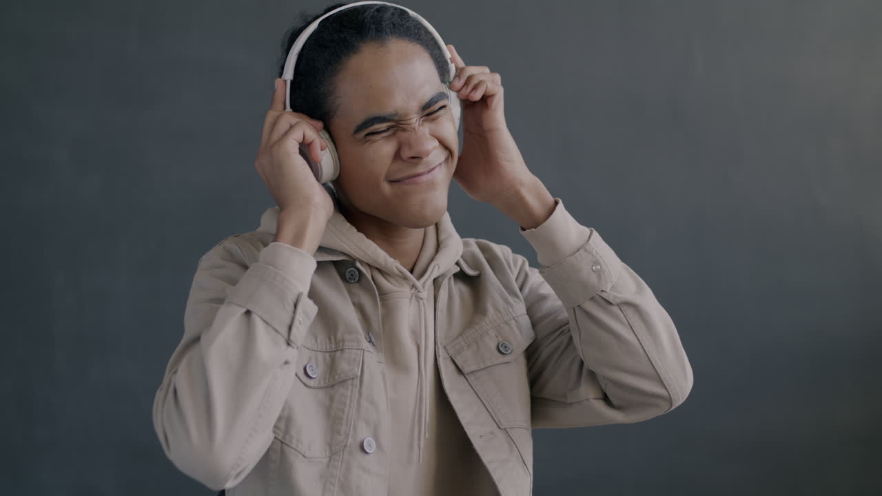 Young Man Listening to Music and Dancing