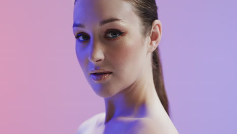 caucasian woman with brown hair and make up looking at camera, copy space, slow motion