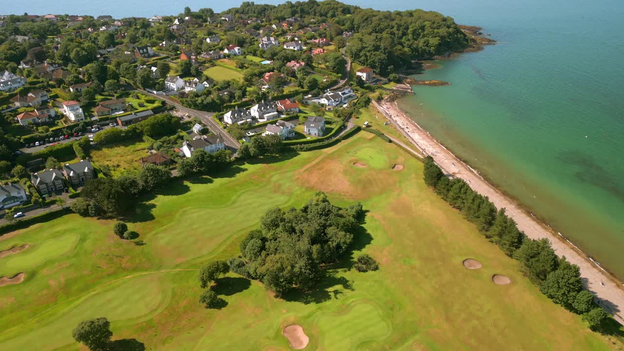 Overhead sweeping 4K 60FPS aerial of Helen's Bay Golf Club in County Down, Northern Ireland on a bright summer day. Produced with Rec709 color