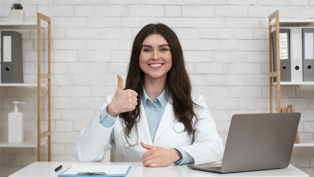 Doctor giving a thumbs up during an online consultation.