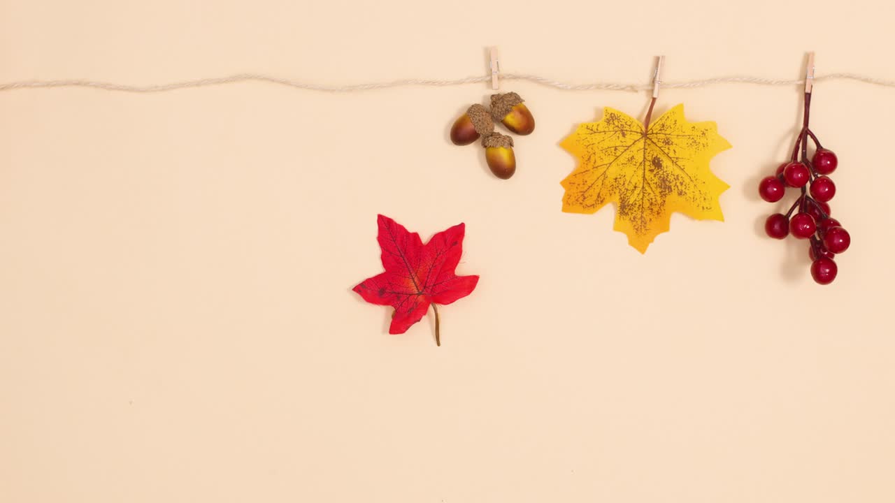 Autumn decorations hooking on the rope and hang. Stop motion