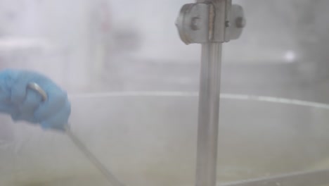 close-up of dipping a spatula in a vat of turkish delight at the factory in order to check the consistency to see if the batch is ready