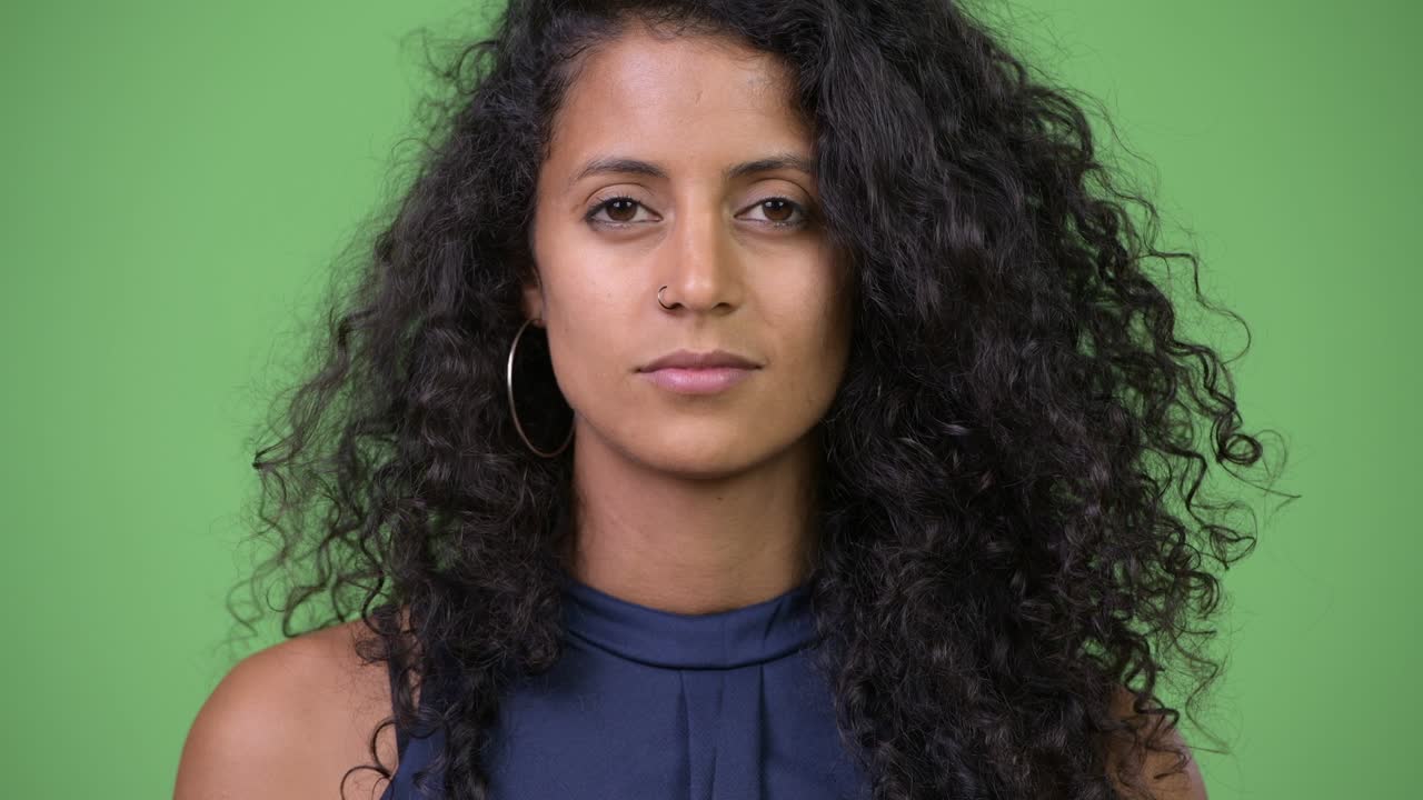 Young beautiful Hispanic businesswoman with curly hair