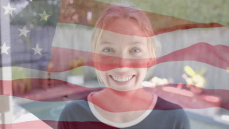 animation of smiling caucasian woman over flag of usa